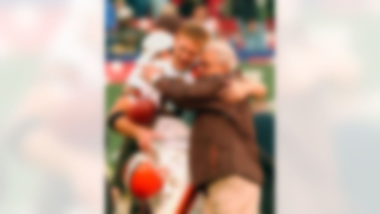 Cleveland Browns defensive coordinator Foge Fazio embraces Browns quarterback Tim Couch as the pair leave the field after the Browns 24-21 come-from behind victory over the New York Jets, Sunday, Oct. 27, 2002, at Giants Stadium in East Rutherford, N.J. (AP Photo/Kathy Willens)