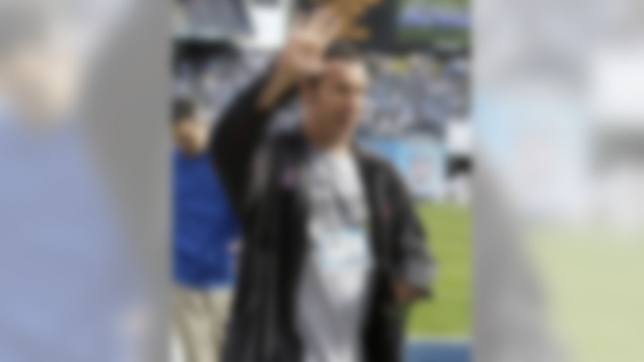 Comedian and actor Adam Sandler reacts as fans cheer for him during warmups before an NFL divisional playoff football game between the San Diego Chargers and the New York Jets, Sunday, Jan. 17, 2010, in San Diego. (AP Photo/Chris Park)