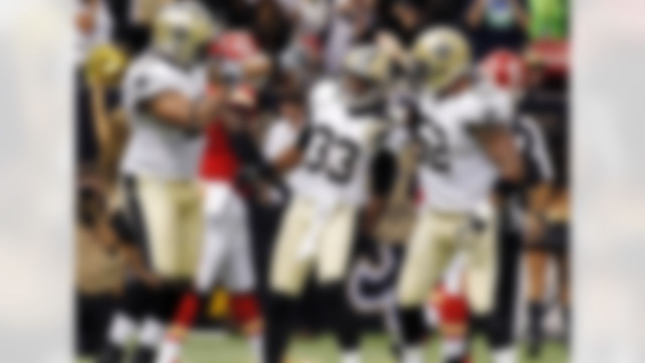 New Orleans Saints cornerback Jabari Greer (33) celebrates his interception with defensive end Will Smith (91) and linebacker Jonathan Casillas (52) in the second half of an NFL football game in New Orleans, Sunday, Sept. 23, 2012. (AP Photo/Jonathan Bachman)
