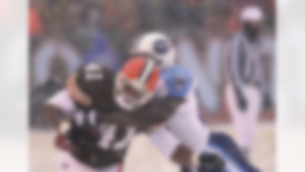 Cleveland Browns running back Travis Prentice is wrapped up by Tennessee Titans' Jevon Kearse after an 8-yard run in the third quarter Sunday, Dec. 17, 2000, in Cleveland. Playing in a driving snow, the Titans shut out Cleveland 24-0 to go to 12-3 on the season. (AP Photo/Tony Dejak)