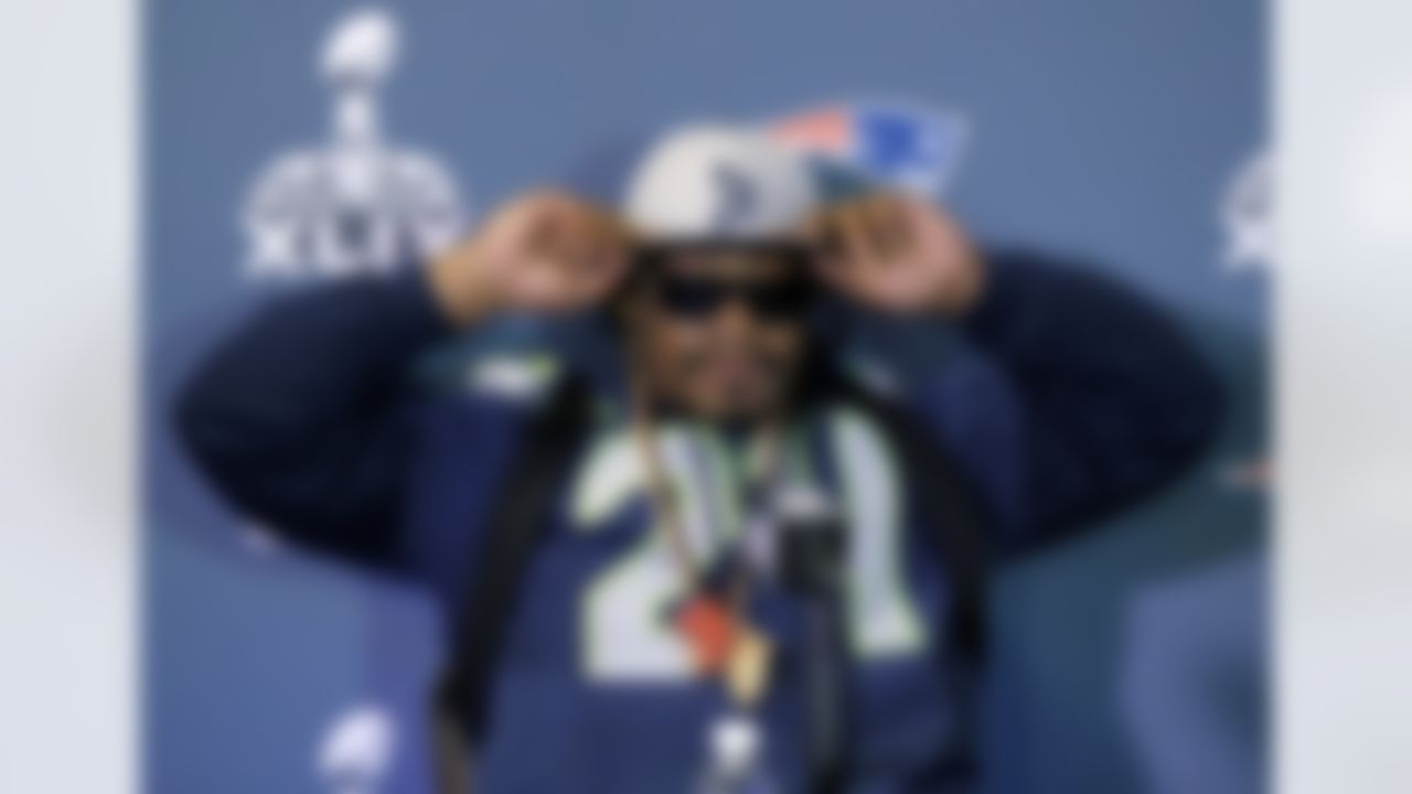 Seattle Seahawks' Marshawn Lynch adjusts his cap during an interview for NFL Super Bowl XLIX football game, Thursday, Jan. 29, 2015, in Phoenix. The Seahawks play the New England Patriots in Super Bowl XLIX on Sunday, Feb. 1, 2015. (AP Photo/Matt York)