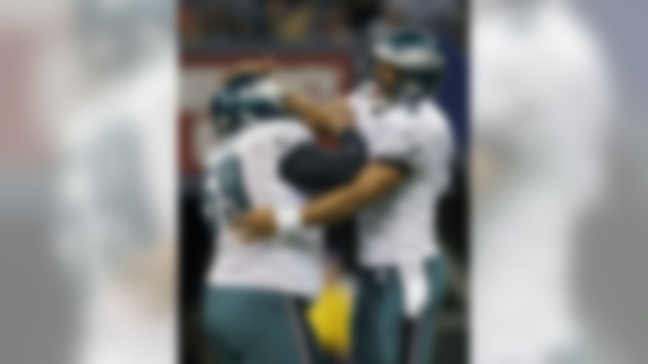 NEW ORLEANS - DECEMBER 23: Quarterback Donovan McNabb #5 and center Nick Cole #59 of the Philadelphia Eagles celebrate a late 4th quarter touchdown during the game against the New Orleans Saints at the Louisiana Superdome December 23, 2007 in New Orleans, Louisiana. The Eagles won 38-23. (Photo by Drew Hallowell/Getty Images)