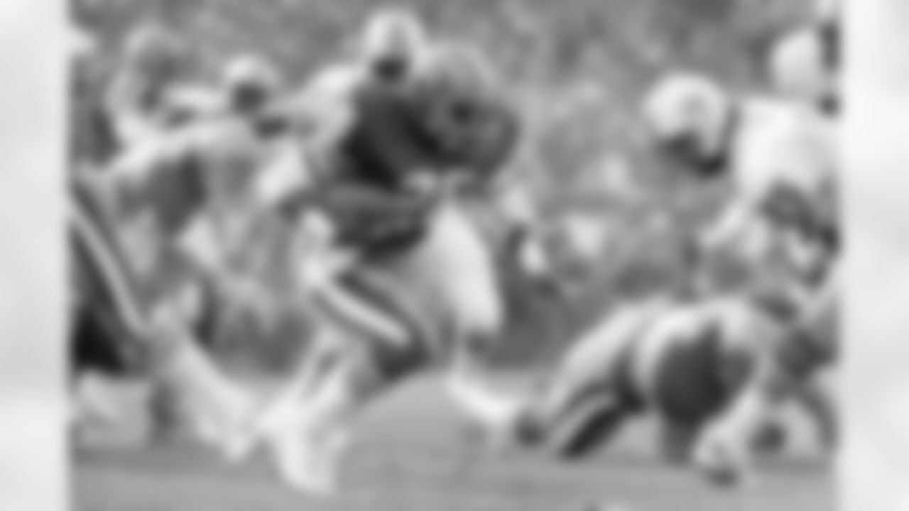 San Francisco 49ers running back Wendell Tyler (26) breaks through Miami Dolphins defense line for a five yard gain during first quarter of Super Bowl XIX at Stanford Stadium in Stanford, CA on January 20, 1985. (Associated Press)