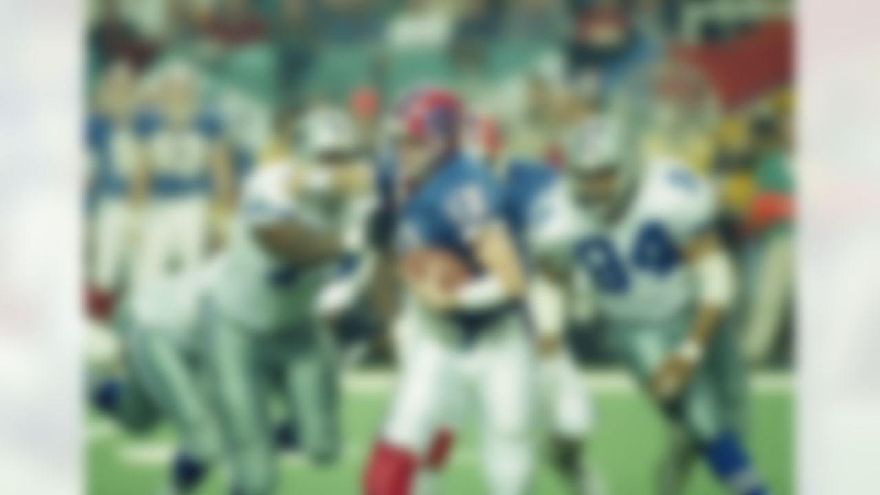 Dallas Cowboys' Jim Jeffcoat (77) and Charles Haley (94) pull down Buffalo Bills quarterback Jim Kelly during the third quarter of Super Bowl XXVIII, Jan. 30, 1994 at Atlanta's Georgia Dome. The Cowboys beat the Bills, 30-13. (AP Photo/Doug Mills)