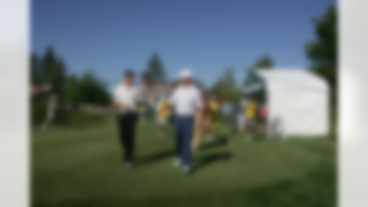 Aaron Rodgers, right, and Matt Ryan walk off the tee box during the American Century Golf Championship at Edgewood Tahoe Golf Course in Stateline, Nev., on Friday, July 17, 2009. (AP Photo/Brad Horn)
