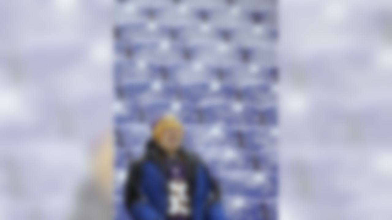 A Minnesota Vikings fan tries to catch snowflakes on his tongue as he watches players warm up before an NFL football game between the Vikings and the Baltimore Ravens, Sunday, Dec. 8, 2013, in Baltimore. A powerful storm system that spread snow, sleet and freezing rain widely across the nation's midsection rumbled toward the densely populated Eastern seaboard on Sunday, promising more of the same. (AP Photo/Patrick Semansky)