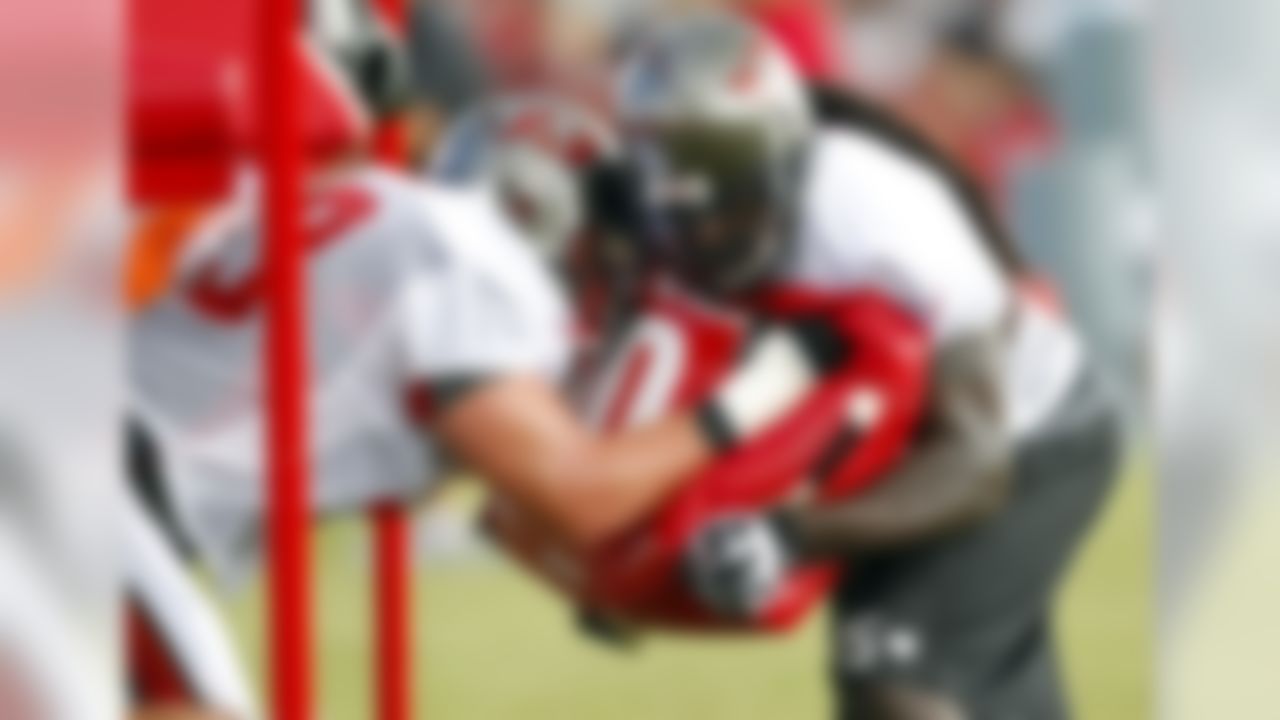 Tampa Bay Buccaneers offensive linemen Derek Hardman, left, and Davin Joseph participate in a blocking drill during a workout at NFL football training camp, Saturday, July 28, 2012, in Tampa, Fla. (AP Photo/Mike Carlson)