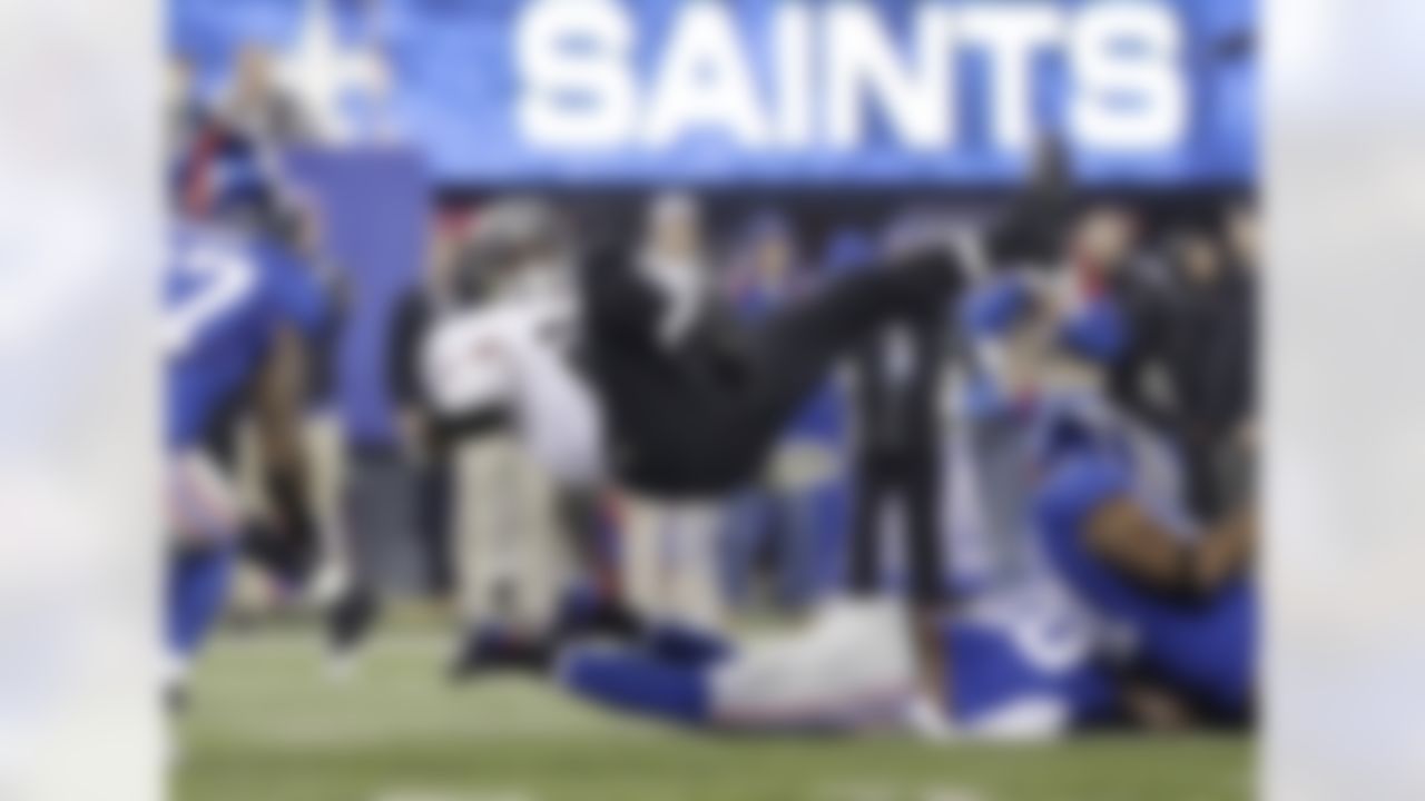 New Orleans Saints running back Mark Ingram (28) is upended during the first half of an NFL football game Sunday, Dec. 9, 2012, in East Rutherford, N.J. Left is New York Giants strong safety Stevie Brown (27). (AP Photo/Kathy Willens)