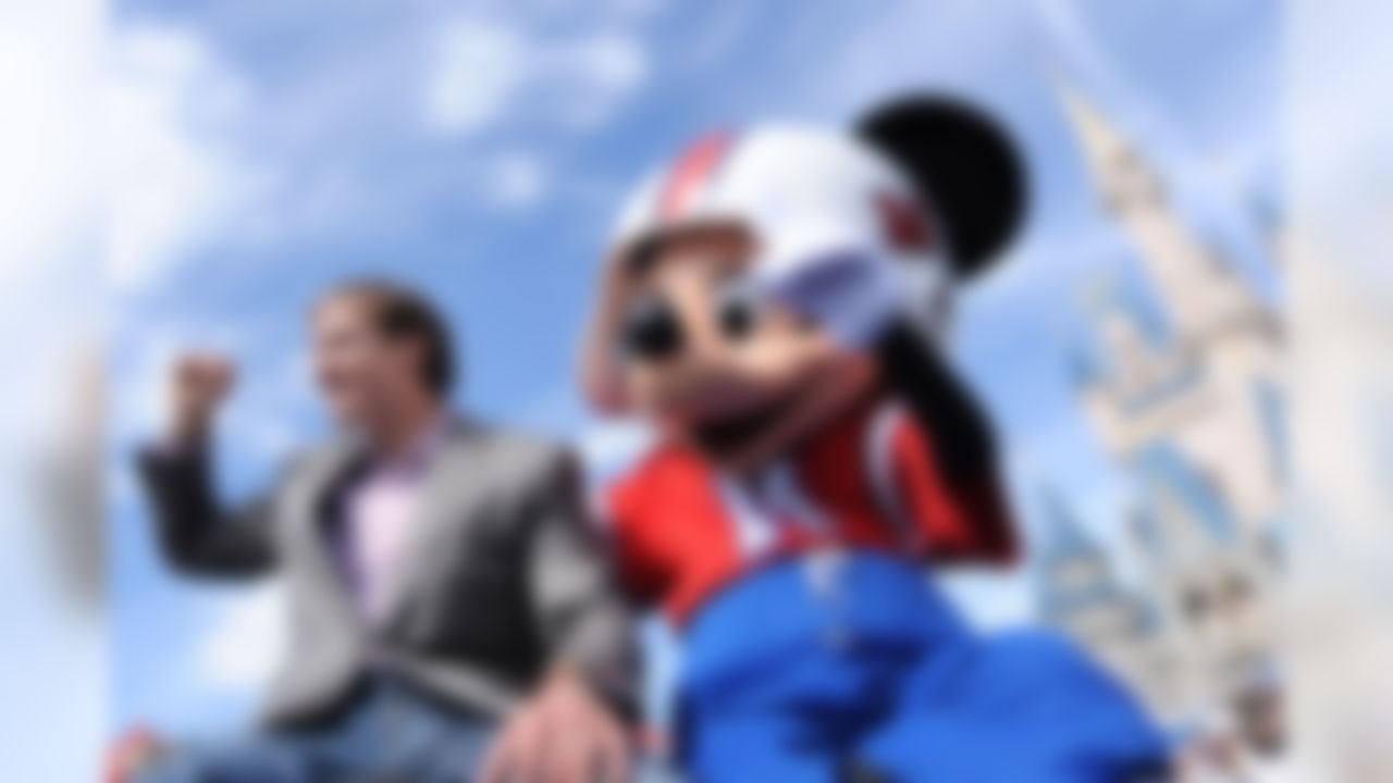 In this Monday, Feb. 8, 2010 photo released by Disney, Super Bowl XLIV MVP, New Orleans Saints quarterback Drew Brees joins Mickey Mouse in a parade in the Magic Kingdom in Lake Buena Vista, Fla., celebrating the Saints' 31-17 victory over the Indianapolis Colts in Sunday's Super Bowl. (AP Photo/Disney, David Roark)