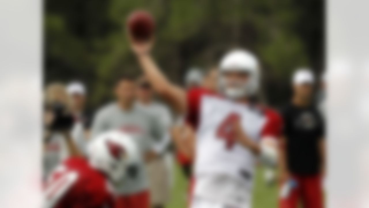 Arizona Cardinals' Kevin Kolb (4) throws the ball as O'Brien Schofield (50) applies pressure during NFL training camp football practice at Northern Arizona University, Friday, July 27, 2012, in Flagstaff, Ariz. (AP Photo/Ross D. Franklin