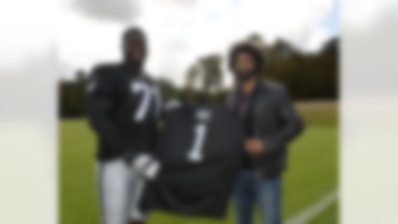 British born Menelik Watson of the Oakland Raiders meets with British boxer David Haye and presents him with a jersey during practice on Wednesday, September 24, 2104 at Pennyhill Park outside of London. The Oakland Raiders and the Miami Dolphins will play in the NFL International Series at Wembley Stadium in London on Sunday, Sept 28. (Sean RyanNFL)