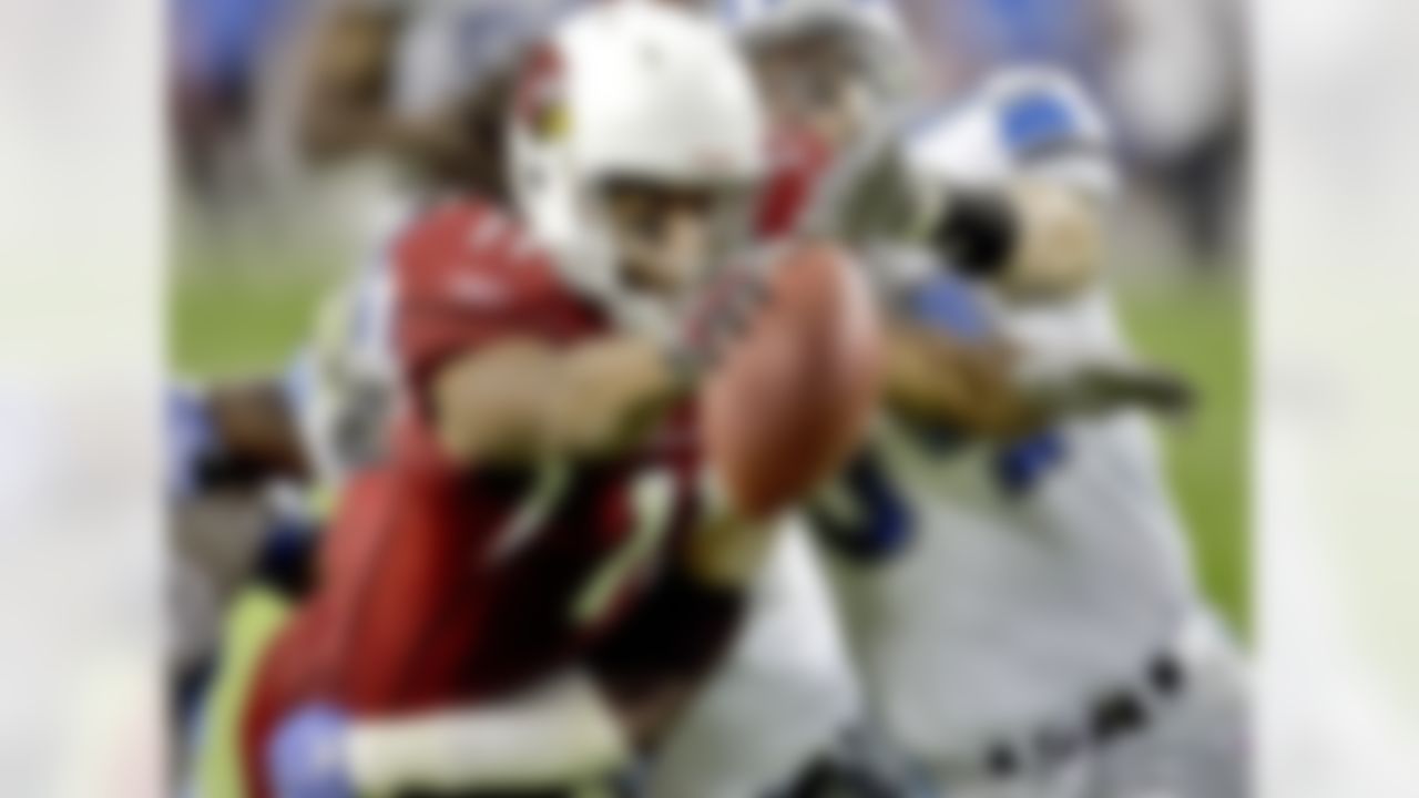 Arizona Cardinals wide receiver Larry Fitzgerald (11) lunges toward the end zone for a touchdown as Detroit Lions linebacker Teddy Lehman, right, defends during the fourth quarter of an NFL football game Sunday, Nov. 11, 2007 in Glendale, Ariz. (AP Photo/Matt York)