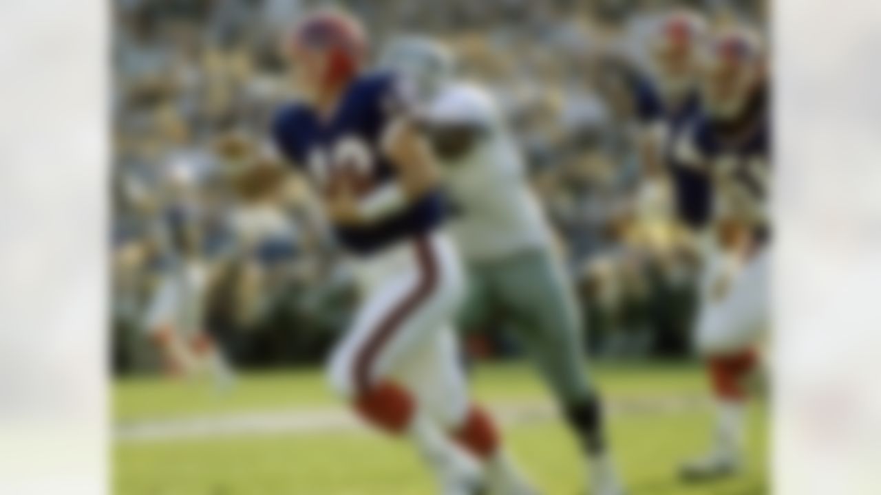 Buffalo Bills Hall of Fame quarterback Jim Kelly (12) runs for his life during Super Bowl XXVII, a 52-17 loss to the Dallas Cowboys on January 31, 1993, at the Rose Bowl in Pasadena, California. (National Football League)