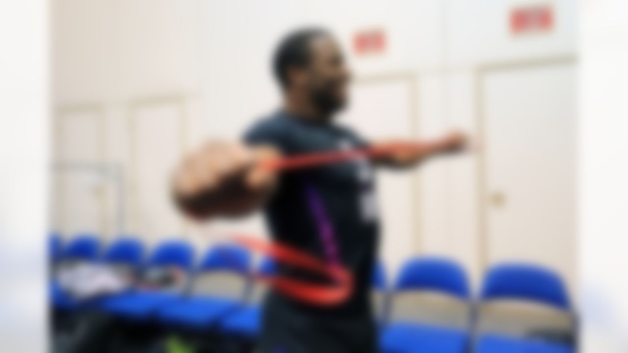 Georgia running back Nick Chubb stretches with an elastic band prior to the bench press during the 2018 NFL Scouting Combine on Thursday, March 1, 2018 in Indianapolis.