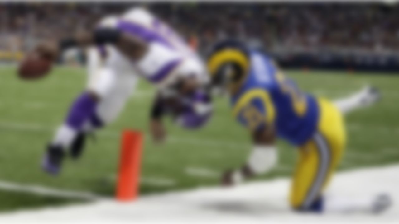 Adrian Peterson crosses into the end zone on a five-yard touchdown run as St. Louis Rams safety Oshiomogho Atogwe defends during a 2009 game in St. Louis. (AP Photo/Michael Conroy)