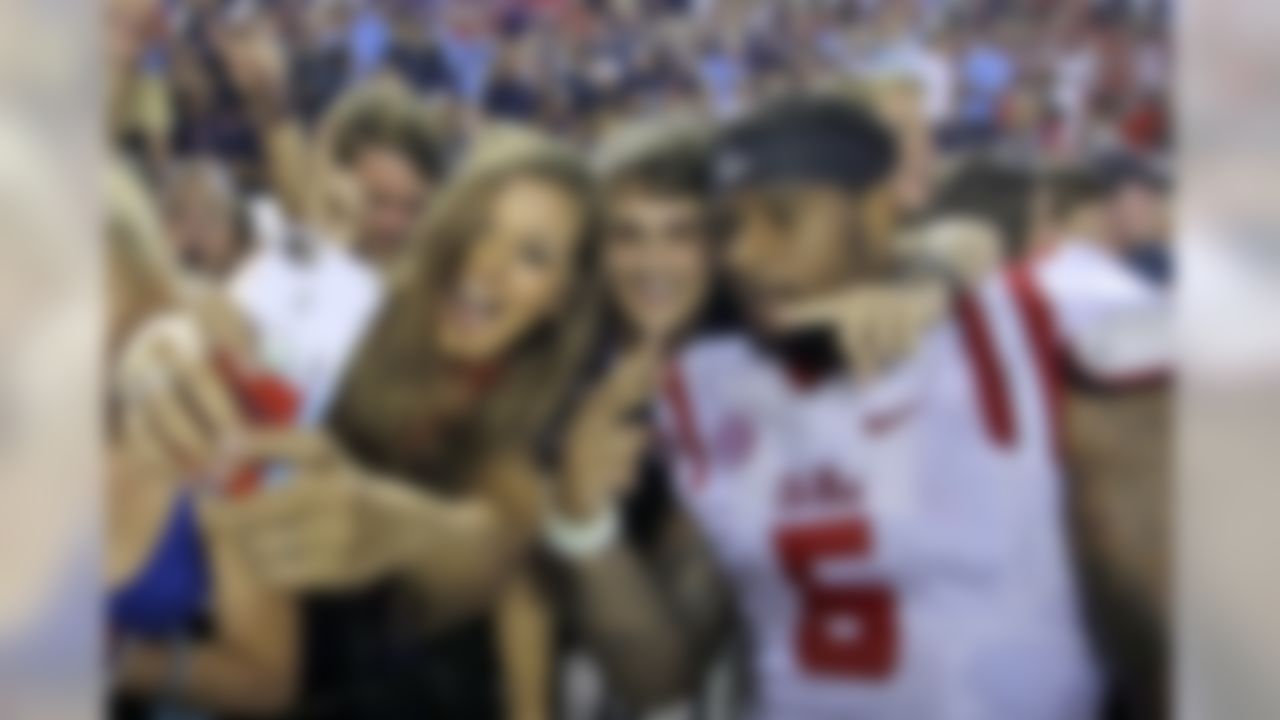 Mississippi defensive tackle Robert Nkemdiche (5) takes a photos with fans after they defeated Alabama in an NCAA college football game, Sunday, Sept. 20, 2015, in Tuscaloosa, Ala. (AP Photo/Butch Dill)