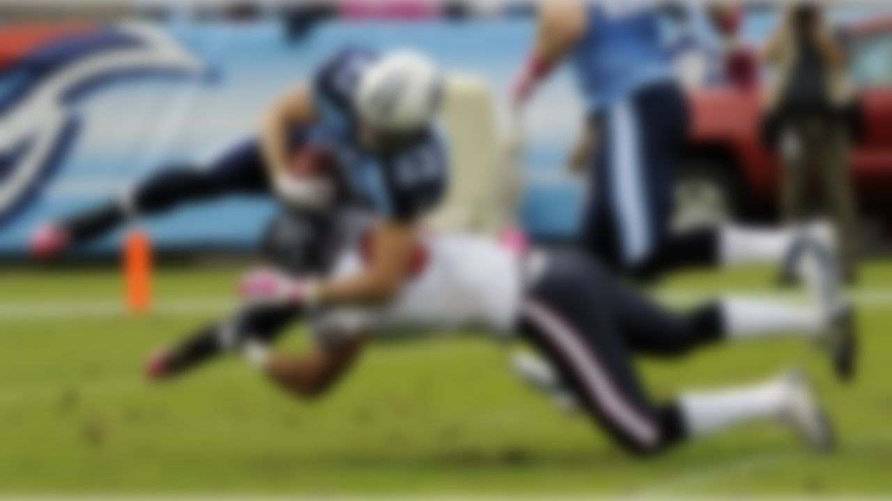 The Texans' Shiloh Keo stops the Titans' Marc Mariani (83) on a kickoff return.