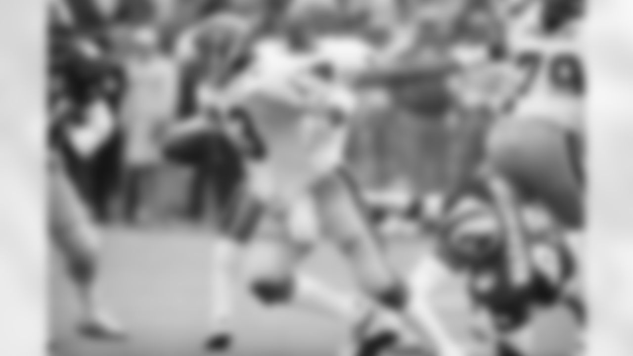 University of Pittsburgh quarterback Dan Marino (13) makes his move to elude the tackle attempt by Southern Methodist University defensive end Russell Washington, right, during first quarter action in the Cotton Bowl, Jan. 1, 1983 in Dallas. Marino gained two yards on the scramble. (AP Photo/Bill Haber)