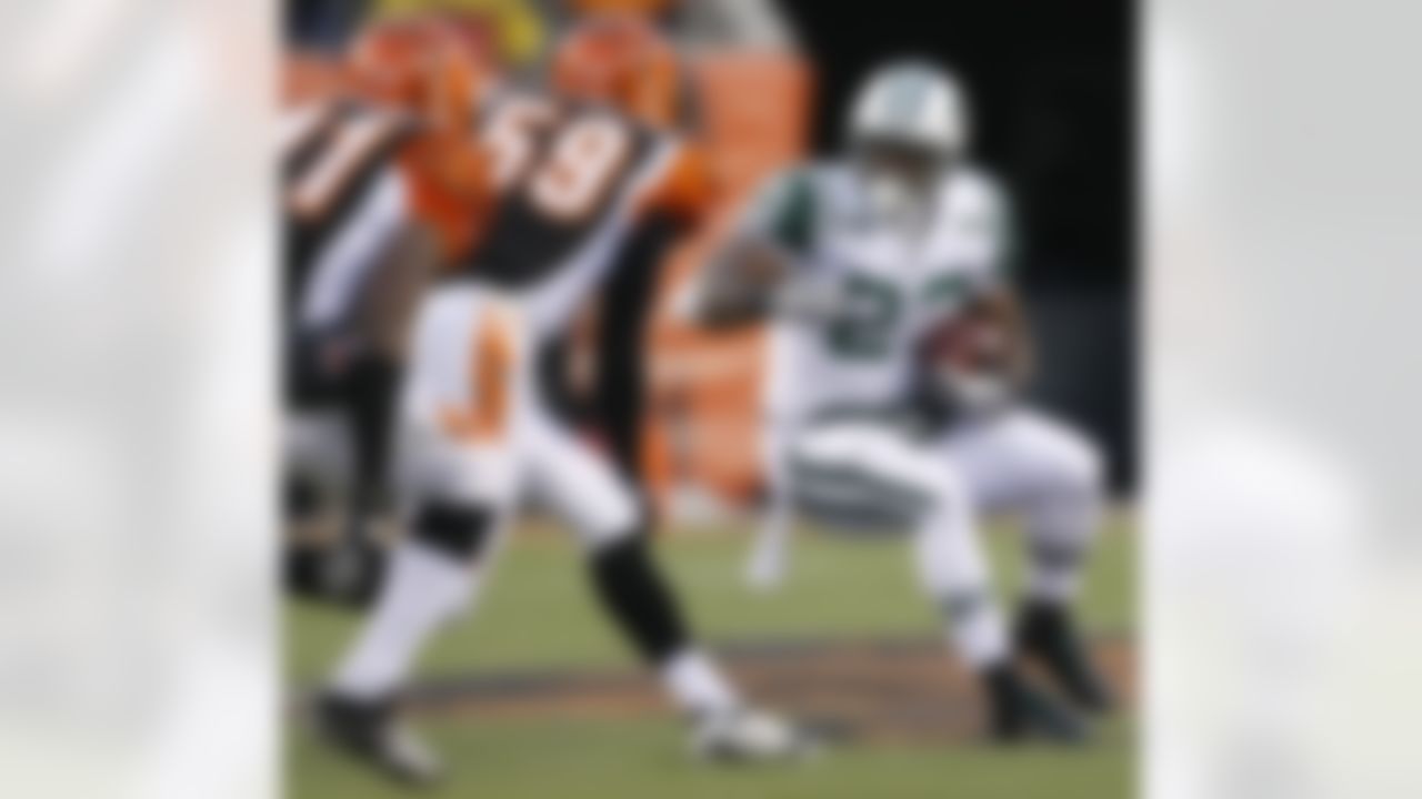 New York Jets running back Shonn Greene (23) is pursued by Cincinnati Bengals linebacker Brandon Johnson (59) and safety Chinedum Ndukwe in the first half of an NFL wild-card playoff football game, Saturday, Jan. 9, 2010, in Cincinnati. (AP Photo/Ed Reinke)