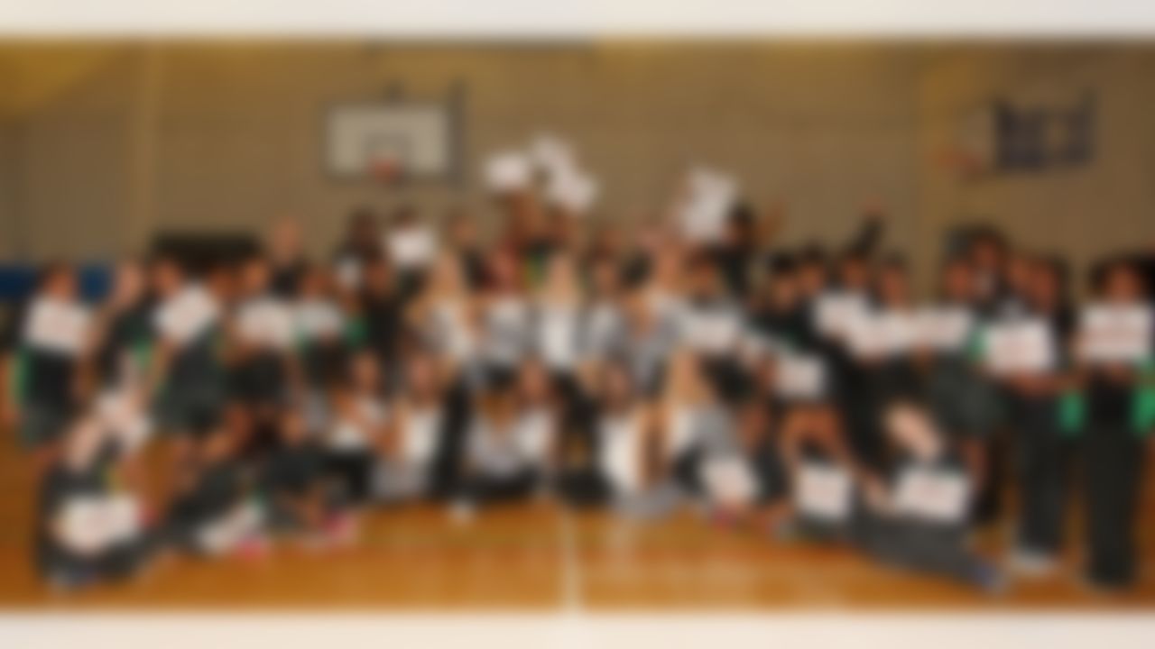 Atlanta Falcons cheerleaders pose for a photo with a student at a local school on Thursday, Oct. 23, 2014 in Brixton, South London. (Nicky Hayes/NFL)