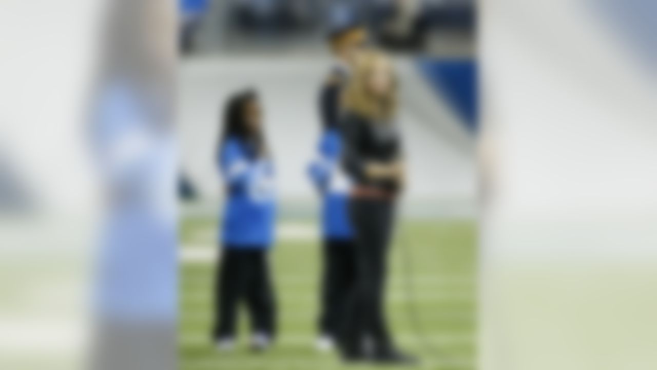 "America's Got Talent" sensation Jackie Evancho prepares to sing the national anthem before the first quarter of an NFL football game between the Detroit Lions and the Green Bay Packers at Ford Field in Detroit, Thursday, Nov. 28, 2013. (AP Photo/Rick Osentoski)