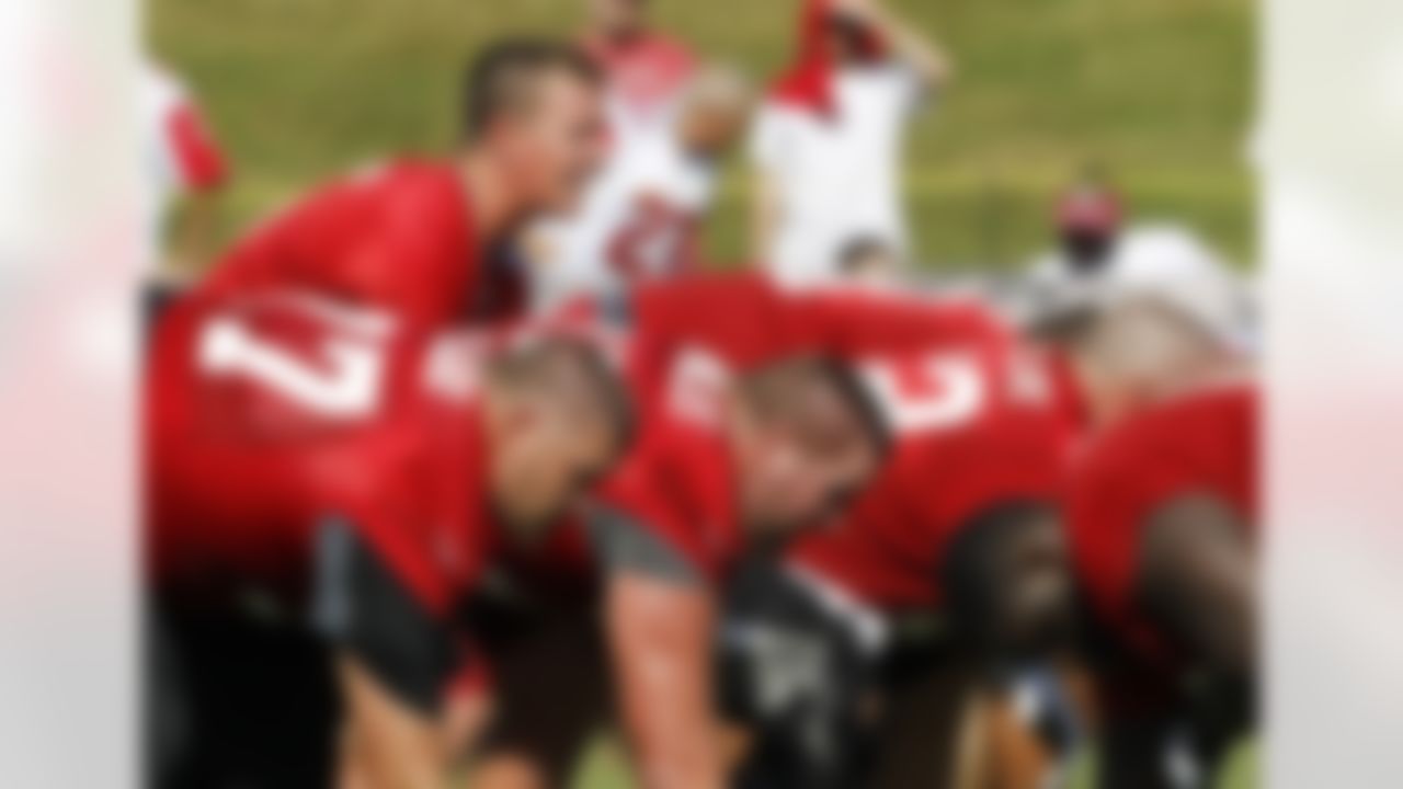 Atlanta Falcons quarterback Matt Ryan, top left, calls signals behind Tyson Clabo, bottom left, and Garrett Reynolds during NFL football training camp in Flowery Branch, Ga., Thursday, July 26, 2012. (AP Photo/John Bazemore)