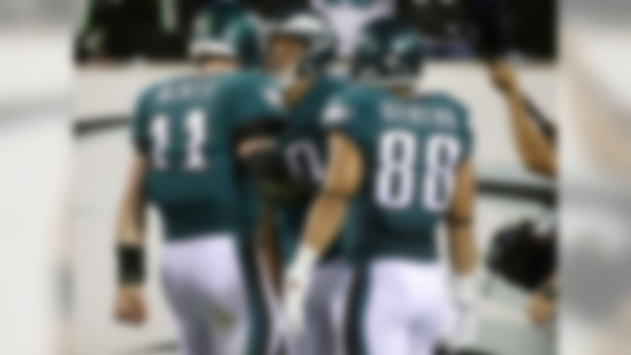 Philadelphia Eagles quarterback Carson Wentz (11) and Philadelphia Eagles wide receiver Mack Hollins (10) celebrate after they connected on a touchdown pass as teammate Trey Burton (88) looks on during the first half of an NFL football game against the Washington Redskins, Monday, Oct. 23, 2017, in Philadelphia.