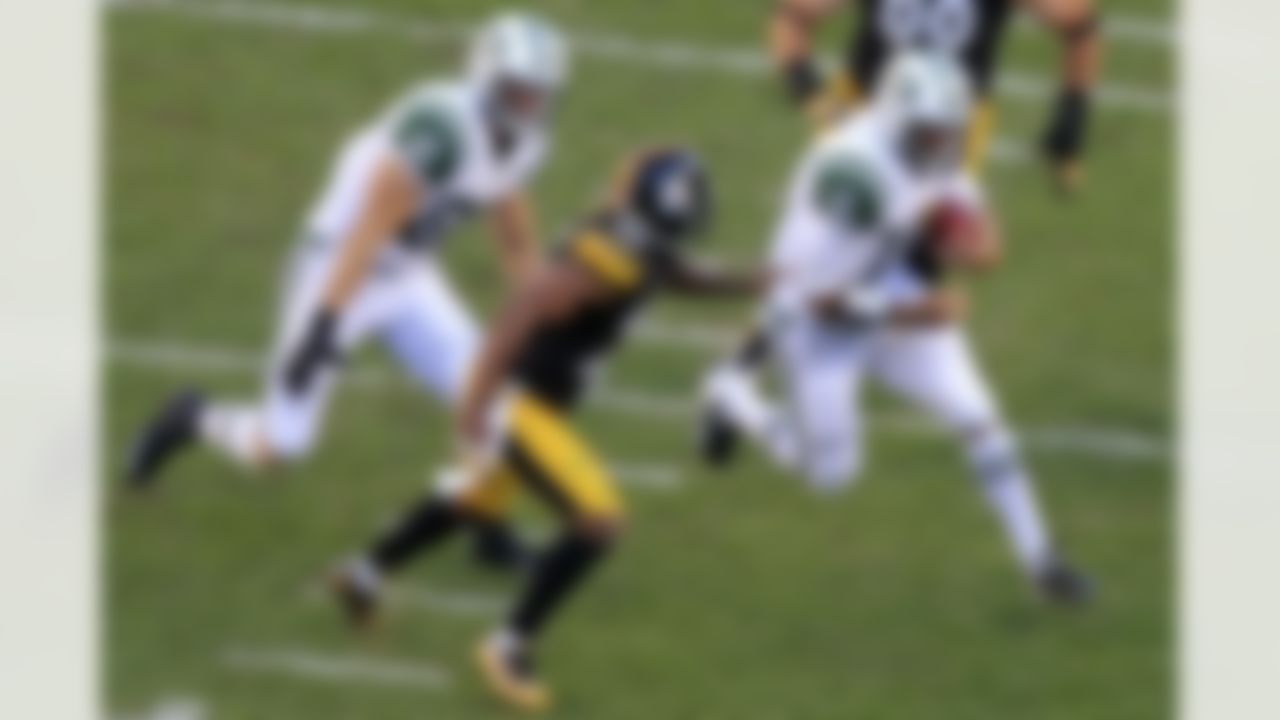 New York Jets quarterback Tim Tebow (15) carries the ball as Konrad Reuland (87) attempts to block Pittsburgh Steelers free safety Ryan Clark (25) during the third quarter of an NFL football game in Pittsburgh on September 16, 2012. (AP Photo/Gene J. Puskar)