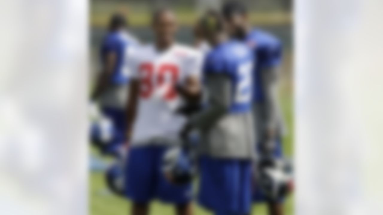 New York Giants wide receiver Victor Cruz (80) talks with safeties Antrel Rolle, center, and Kenny Phillips during a break at NFL football training camp in Albany, N.Y., Sunday, July 29, 2012. Coming off a record-setting season for the Super Bowl champion Giants, Cruz isn't on "Cruz" control. (AP Photo/Kathy Willens)