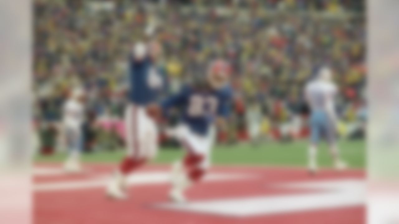Buffalo Bills wide receiver Andre Reed (83) and teammate Keith McKeller celebrate Reed's third touchdown during the fourth quarter against the Houston Oilers, Jan. 4, 1993 at Rich Stadium in Orchard Park, N.Y. The Bills staged the biggest comeback in NFL history to beat the Oilers 41-38 in overtime. (Bill Sikes/Associated Press)