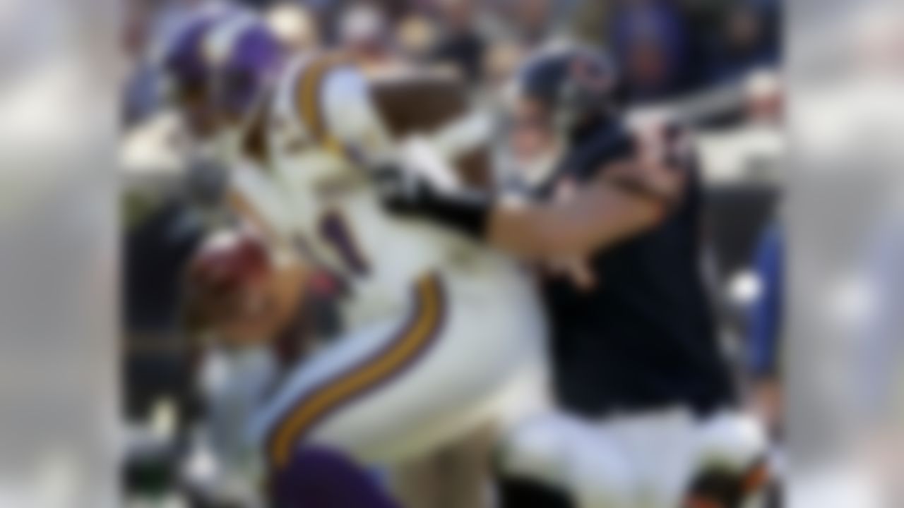 Chicago Bears' Brian Urlacher, right, sacks Minnesota Vikings quarterback Daunte Culpepper for a 12-yard loss during the third quarter Sunday, Oct. 16, 2005, in Chicago. The sack was the first of two on the day for Urlacher as he helped the Bears to a 28-3 win. (AP Photo/Jeff Roberson)