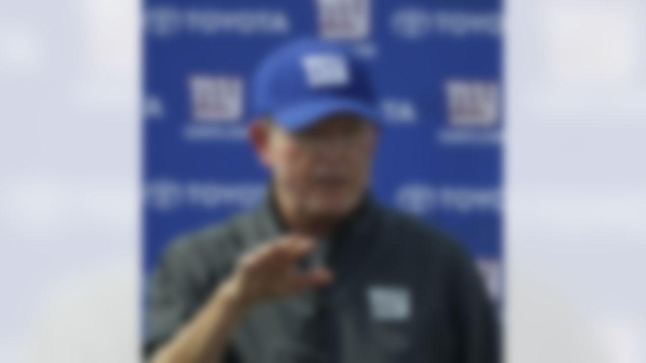 New York Giants head coach Tom Coughlin gestures during a news conference following the team's workout at the New York Giants NFL football training camp in Albany, N.Y., Sunday, July 29, 2012. (AP Photo/Kathy Willens)