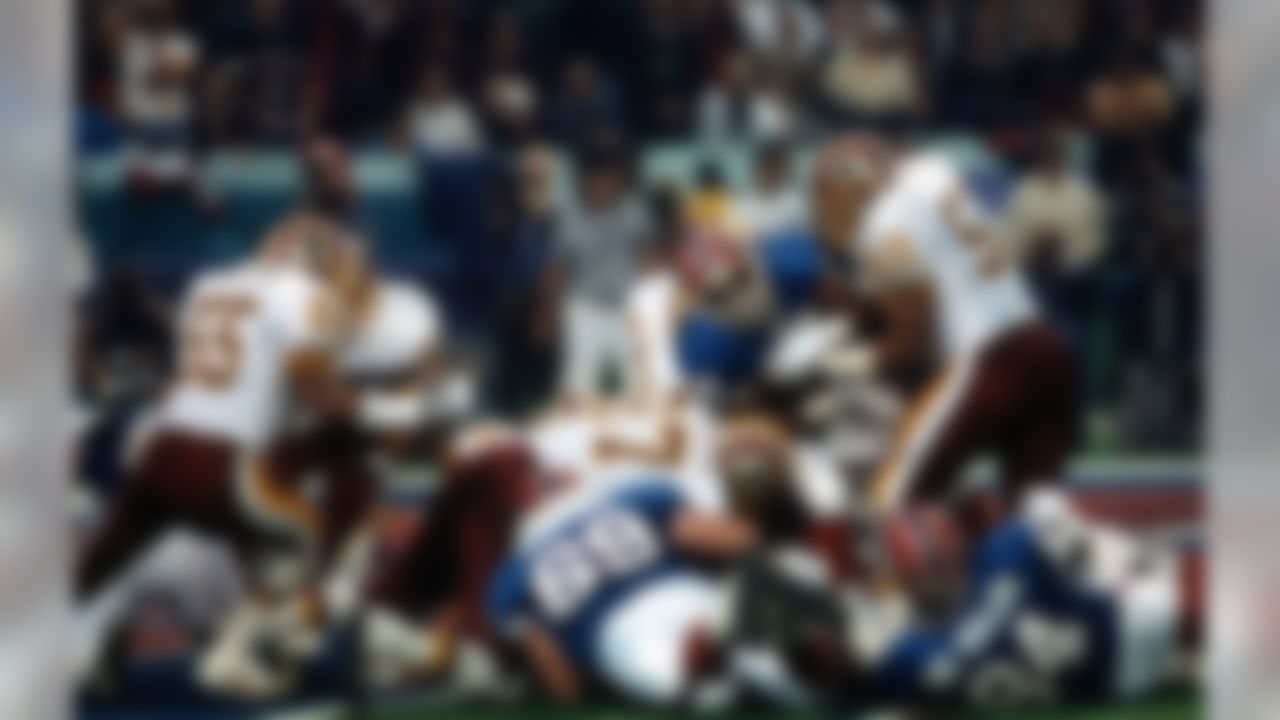 Buffalo Bills Hall of Fame running back Thurman Thomas (34) is stopped by Washington Redskins linebacker Ravin Caldwell (50) and defensive end James Geathers (97) during Super Bowl XXVI game in Minneapolis, on January 26, 1992. (AP Photo/Vernon Biever)