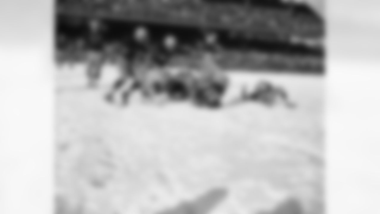 Rob Goode (21), Washington Redskins halfback, bangs his head and shoulder on the snow-covered Griffith Stadium turf with his feet in the air in the first period of a game with the Pittsburgh Steelers in Washington, on Dec. 16, 1951. (AP Photo/HWG)