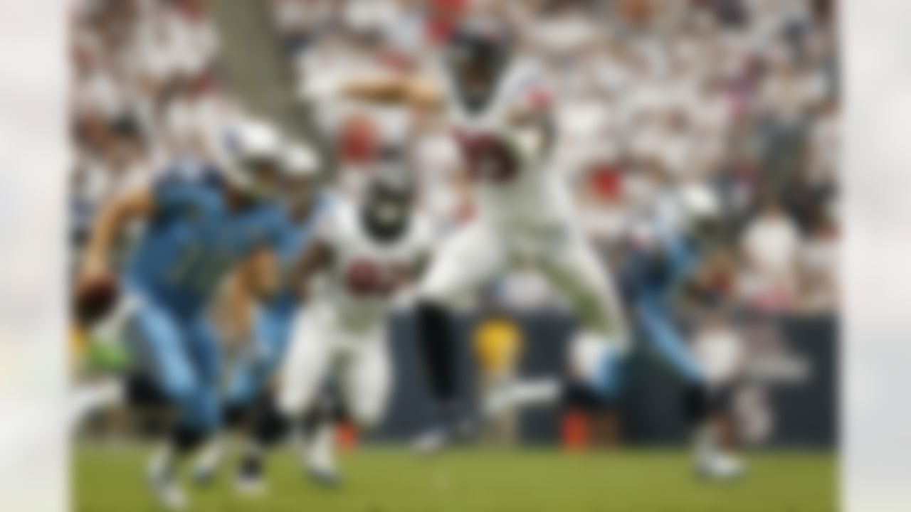 Houston Texans defensive end J.J. Watt (99) leaps through the air as he goes after Tennessee Titans quarterback Jake Locker (10) during an NFL football game at Reliant Stadium on September 15, 2013 in Houston, Texas. Houston won 30-24. (Aaron M. Sprecher/NFL)