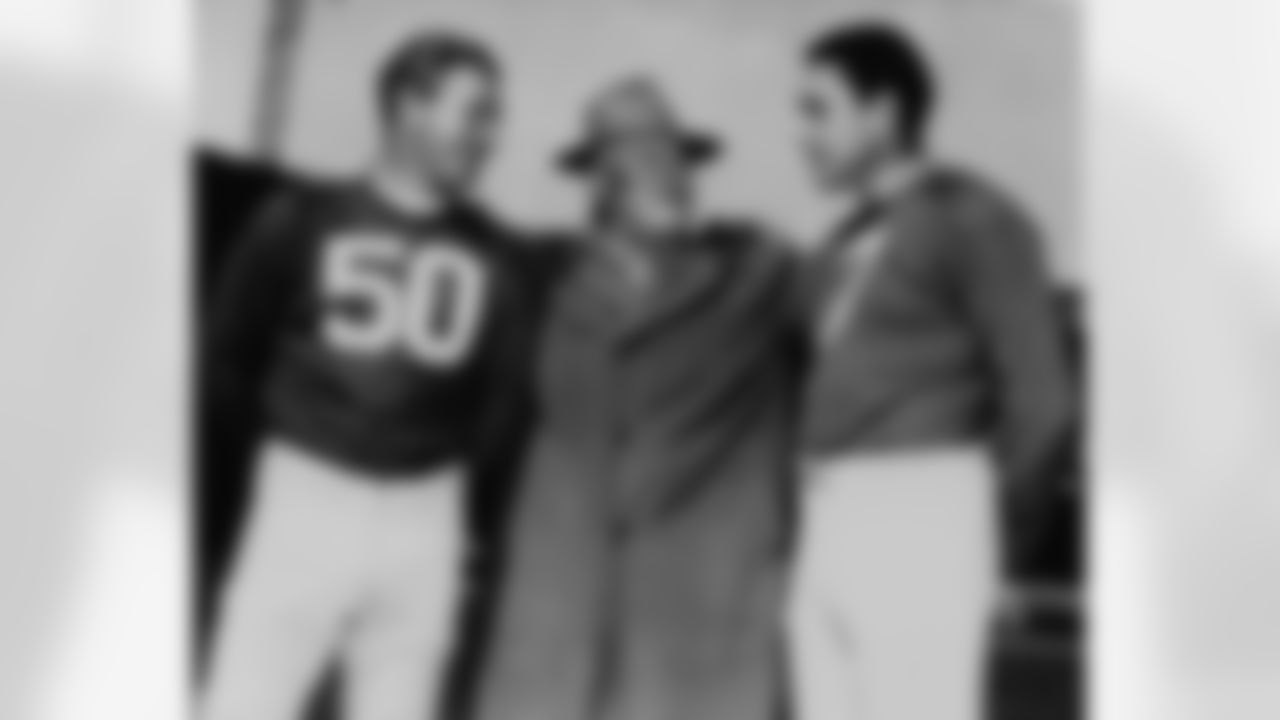 Coach Steve Owen, center, of the New York Giants football team, talks with Ken Strong, left and Mel Hein, right, during a practice session in New York City Oct. 11, 1945 for their opening game of the season Oct. 14 against the Boston Tigers at Yankee Stadium. (Associated Press)