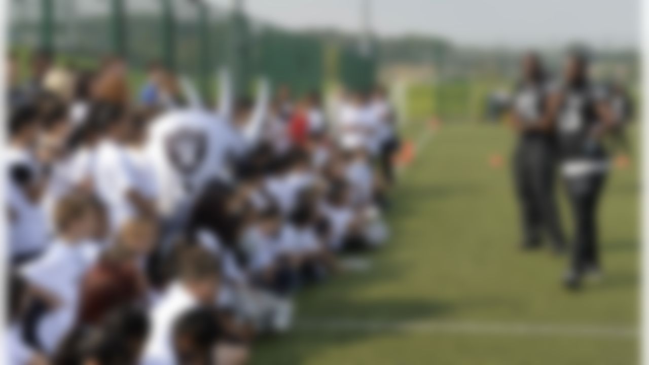 Oakland Raiders Justin Tuck and Marcel Reece speak with a group of kids during a football clinic in London. The Oakland Raiders and the Miami Dolphins play in the NFL International Series at Wembley Stadium in London. (Sean Ryan/NFL)