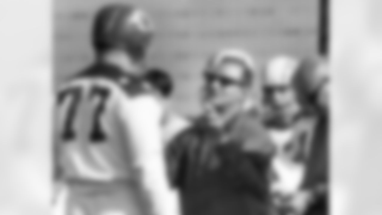 San Diego Chargers head coach Sid Gillman, center, directs American Football League All-Star and Kansas City Chiefs tackle Jim Tyrer (77) during a morning work out for a game against the Buffalo Bills in this Jan 11, 1965 photo. (AP Photo)
