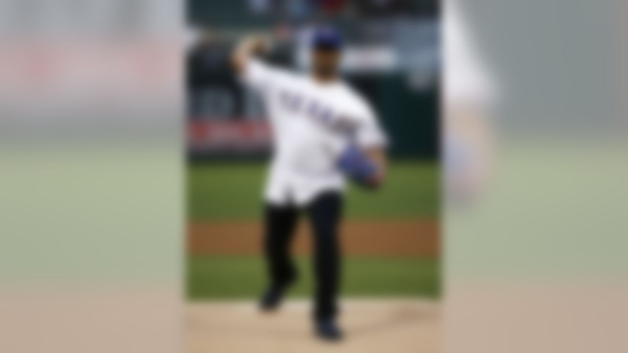 Seattle Seahawks quarterback Russell Wilson throws out the ceremonial first pitch before a baseball game between the Texas Rangers and the Philadelphia Phillies, Wednesday, April 2, 2014, in Arlington, Texas. (AP Photo/Jim Cowsert)