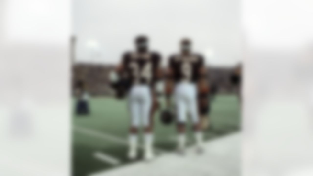 Chicago Bears quarterback Jim McMahon (9) stands with running back Walter Payton (34) during the National Anthem before a 20-7 victory over the New Orleans Saints on October 7, 1984, at Soldier Field in Chicago, Illinois. During this game, Payton broke Jim Brown's career rushing record. (Bruce Dierdorff/NFL)