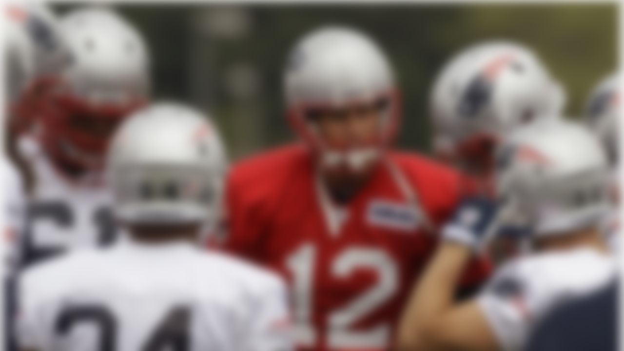 New England Patriots quarterback Tom Brady (12) huddles his team as he calls a play during practice on the second day of training camp at the NFL football team's facility in Foxborough, Mass., Friday, July 27, 2012. (AP Photo/Stephan Savoia)