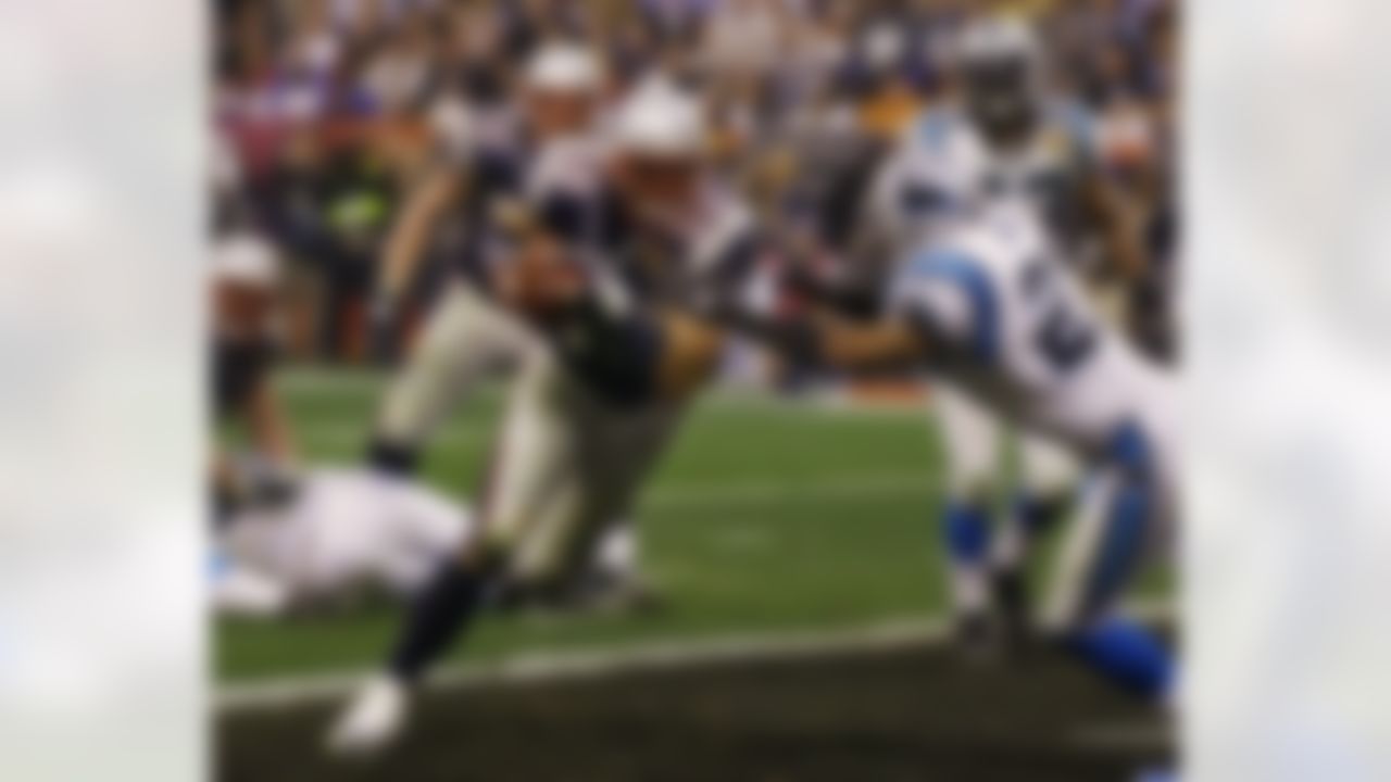 New England Patriots' Mike Vrabel (50) carries the ball against Carolina Panthers defender Deon Grant (27) into the endzone for a touchdown in the fourth quarter of Super Bowl XXXVIII at the Reliant Stadium in Houston, TX Sunday Feb. 1, 2004. (AP Photo/Elise Amendola)