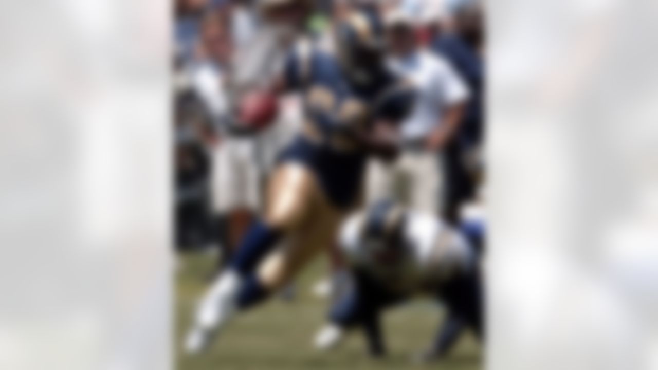 St. Louis Rams running back Marshall Faulk leaves San Diego Chargers linebacker Bern Leber in his wake while gaining 11 yards on a swing pass in the first quarter of their preseason game Sunday, Aug. 21, 2005, in San Diego. (AP Photo/Denis Poroy)