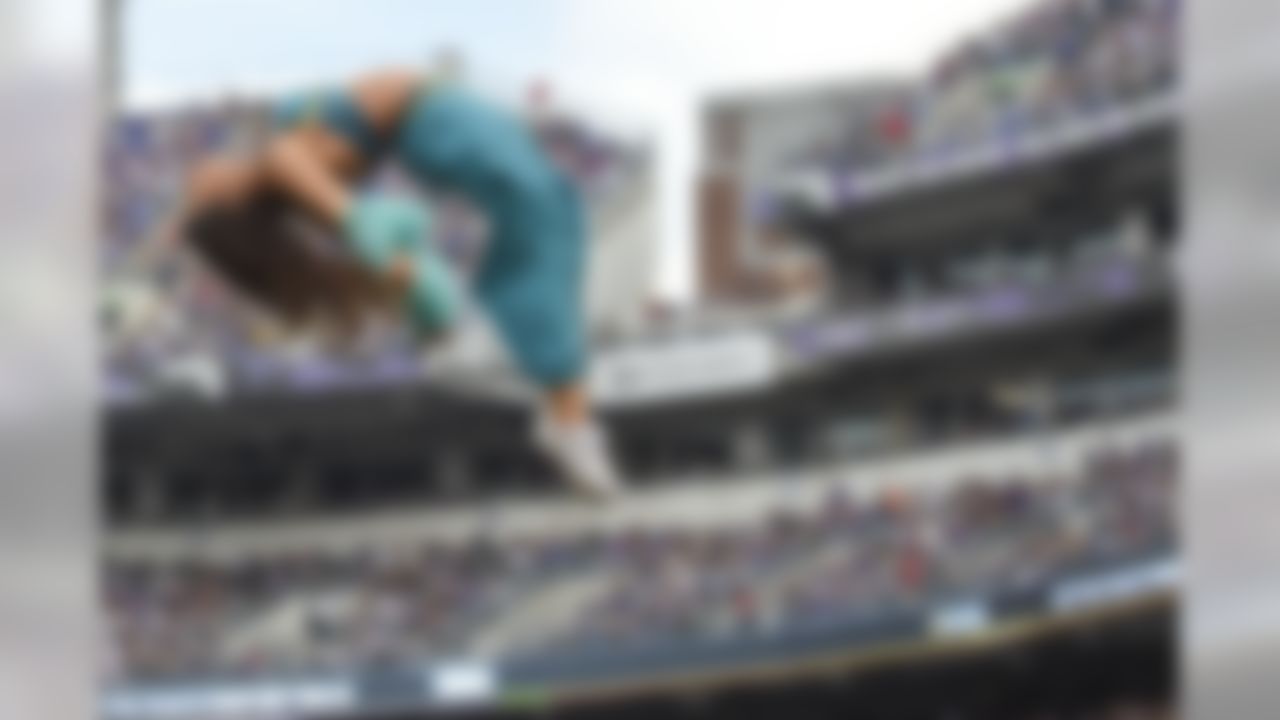 A Baltimore Ravens cheerleader flys through the air during the second half of an NFL football game against the San Diego Chargers in Baltimore, Sunday, Nov. 1, 2015. (AP Photo/Nick Wass)