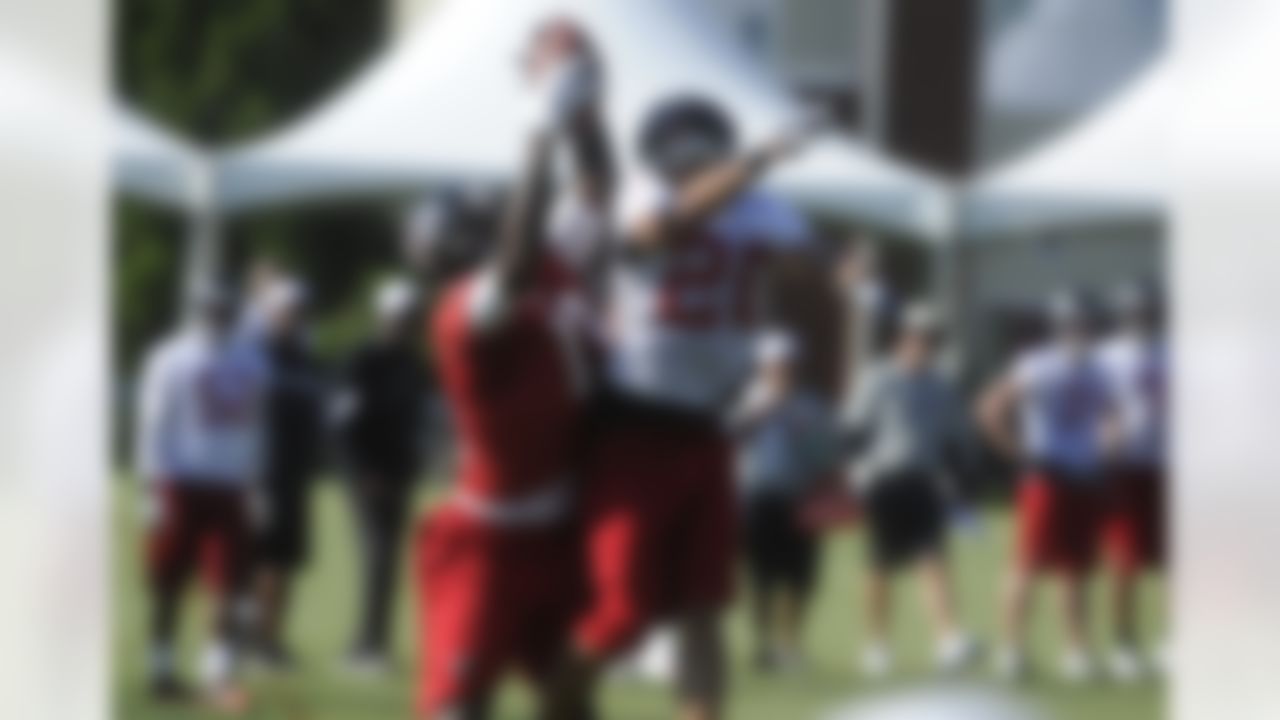 Atlanta Falcons wide receiver Julio Jones, left, and cornerback Brent Grimes (20) vie for a pass during an NFL football training camp session on Saturday, July, 28, 2012. (AP Photo/John Amis)