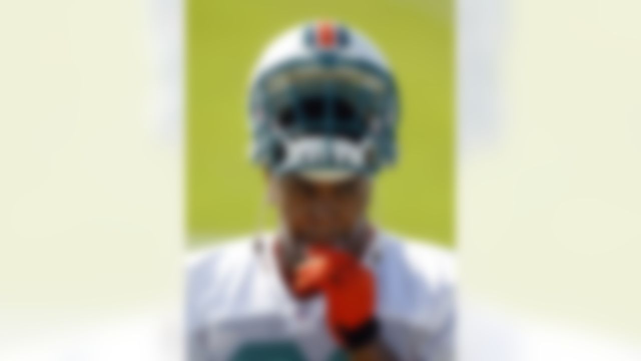 Miami Dolphins' Cameron Wake takes out his mouth piece during NFL football training camp practice in Davie, Fla., Friday, July 27, 2012. (AP Photo/Alan Diaz)