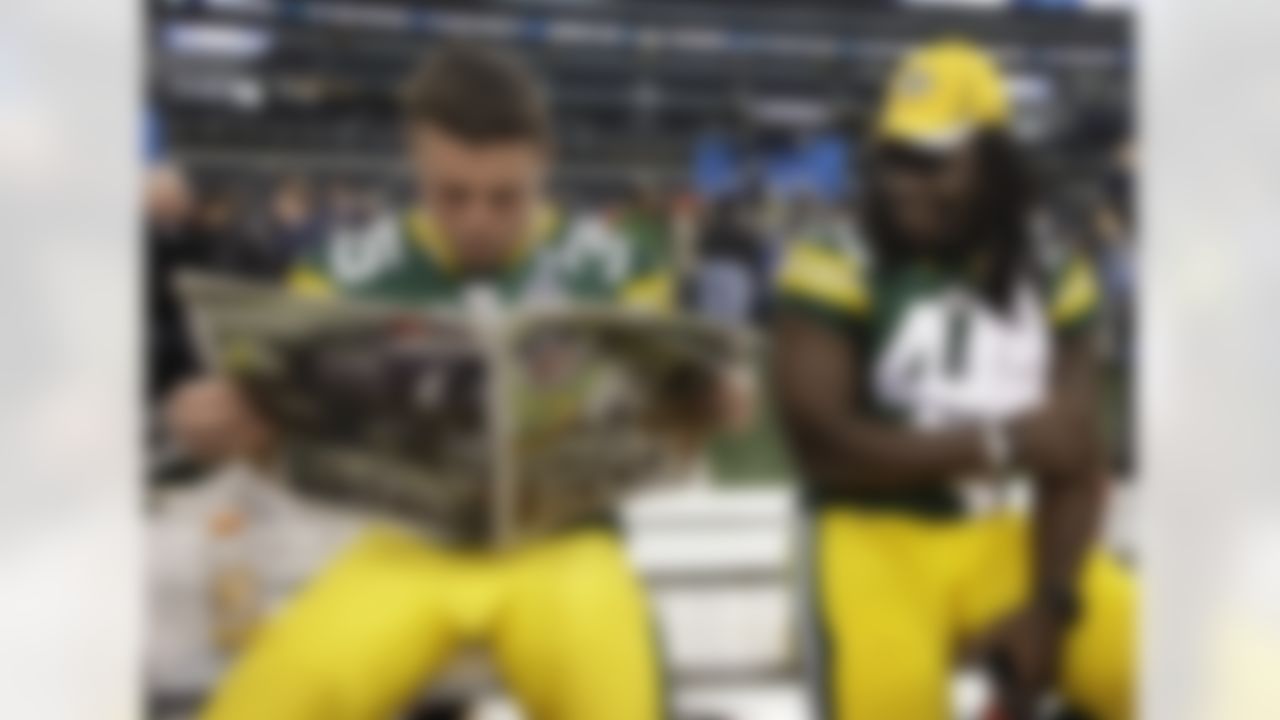 Green Bay Packers' Quinn Johnson watches as Korey Hall (35) reads a paper during media day for NFL football Super Bowl XLV Tuesday, Feb. 1, 2011, in Arlington, Texas. (AP Photo/David J. Phillip)