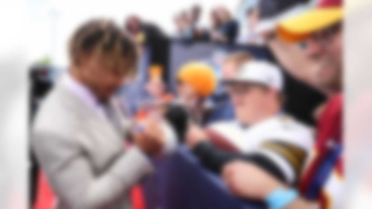 LSU running back Derrius Guice signs autographs for fans.