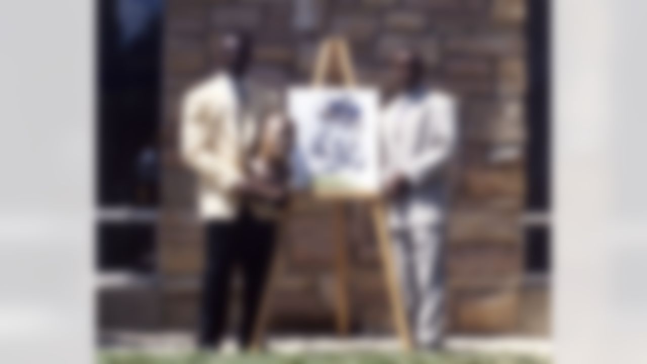 Walter Payton (L) and son Jarrett Payton pose, with the bust and painting, during induction ceremony into the Pro Football Hall of Fame on July 31, 1993 at Fawcett Stadium in Canton, Ohio. (Pro Football Hall of Fame)