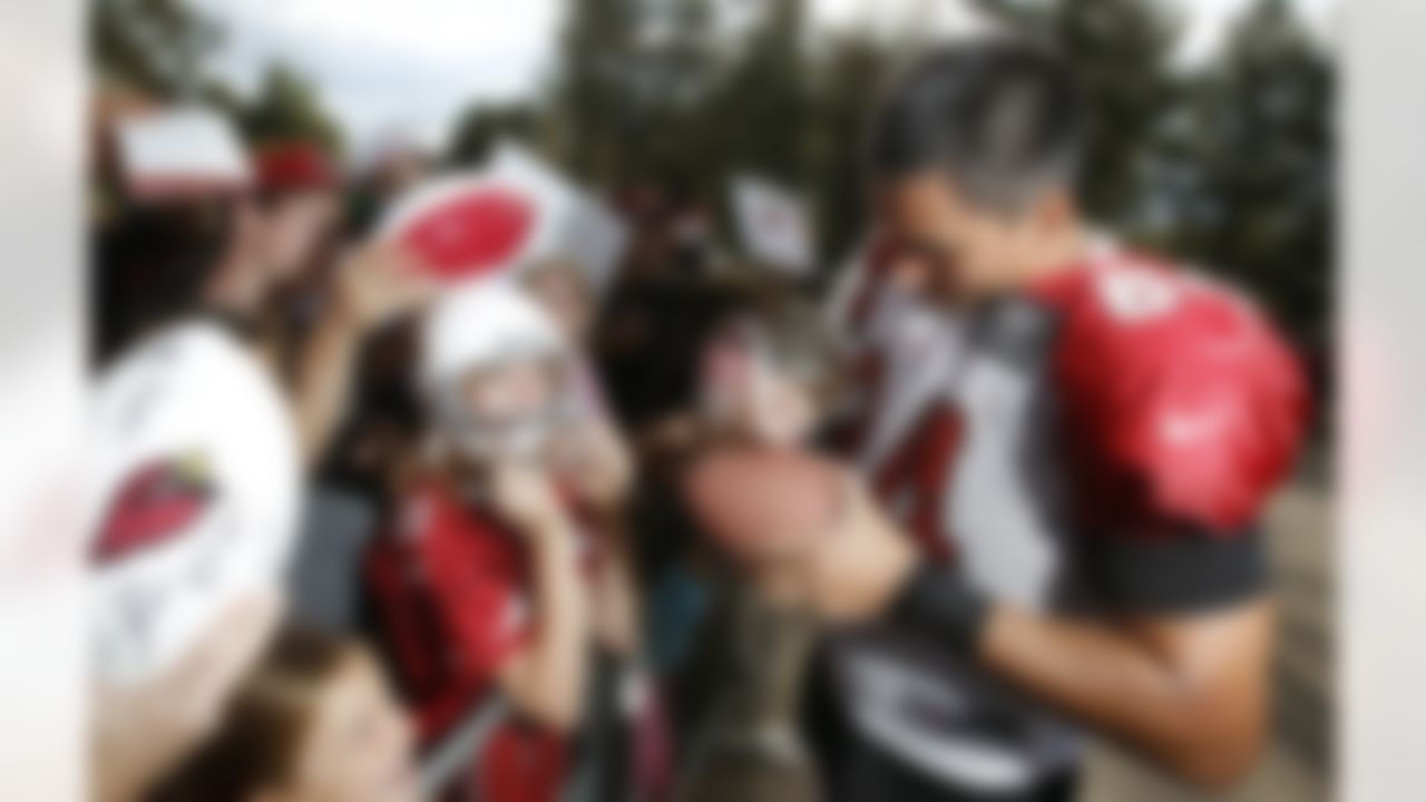 Arizona Cardinals' Rob Housler, right, signs autographs after NFL training camp football practice at Northern Arizona University, Friday, July 27, 2012, in Flagstaff, Ariz. (AP Photo/Ross D. Franklin)